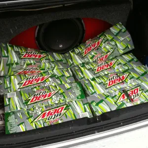 A car trunk completely filled with multiple twelve-packs of Mountain Dew soda stacked on top of each other.